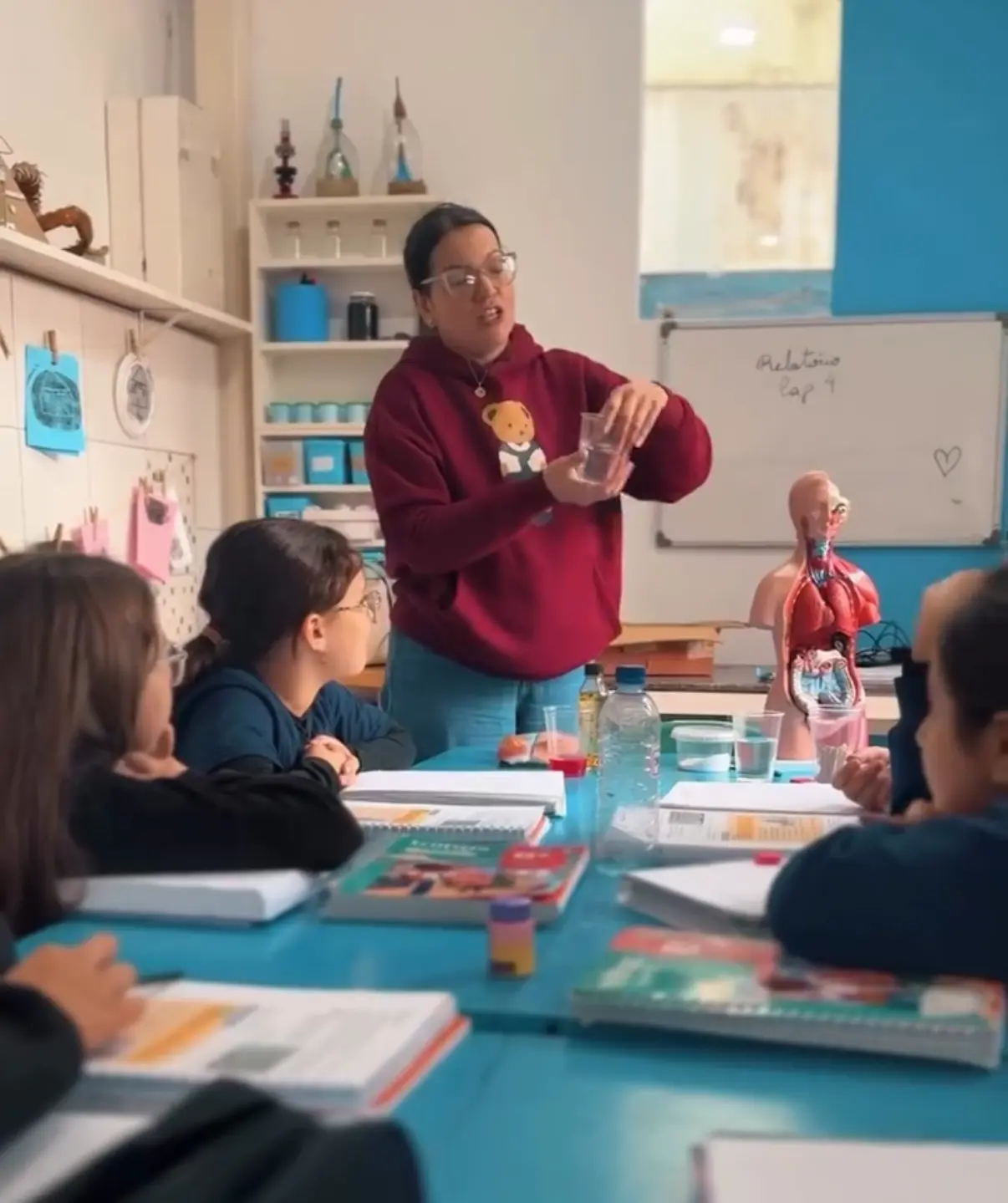 Professora desenvolvendo atividade prática de Ciências com os alunos